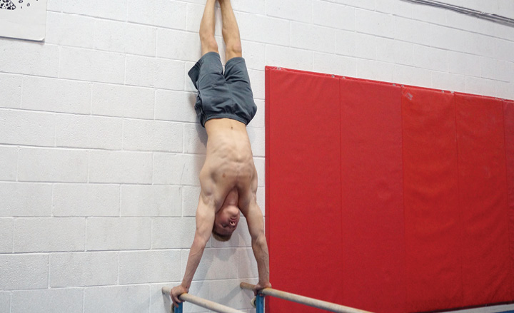 Wall supported handstand pushups - The Body Dojo