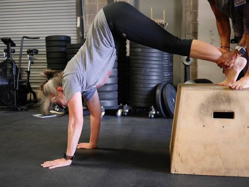 GymnasticBodies student gets comfortable being inverted at a GB Seminar.