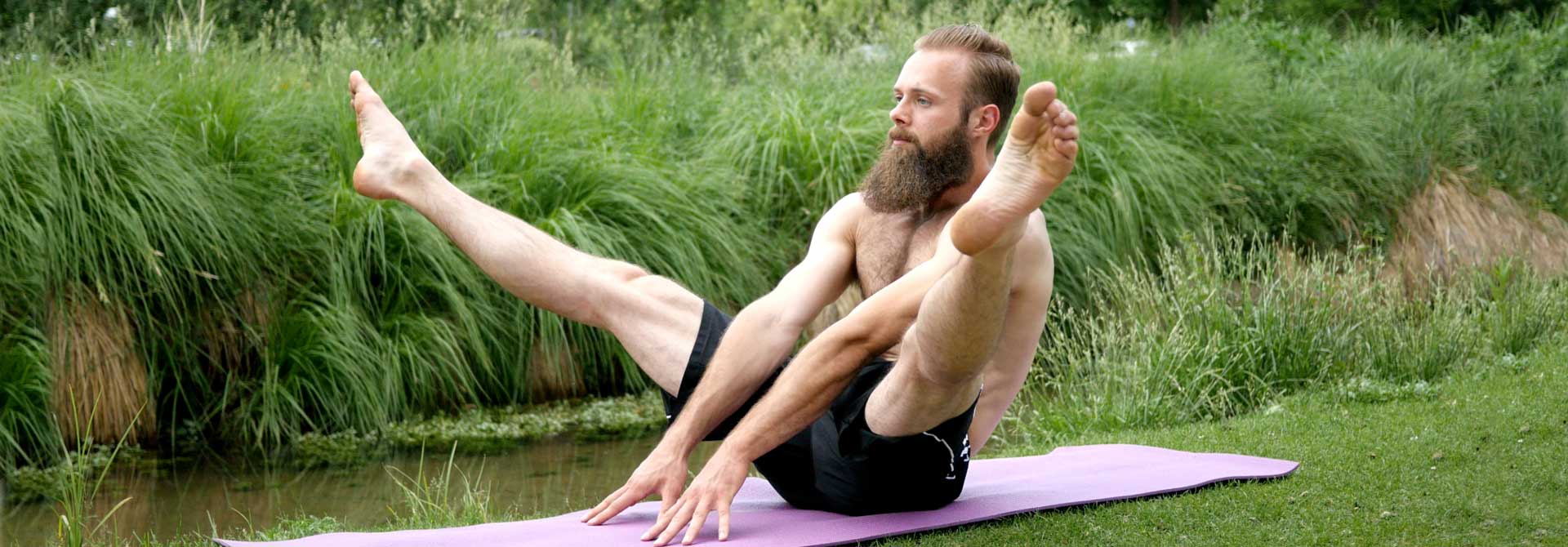 GymnasticBodies athlete doing a straddle up core exercise.