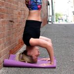 GymnasticBodies athlete performs a headstand for handstand training.