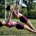 GymnasticBodies athlete perform ring rows.