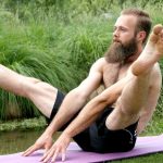 GymnasticBodies athlete doing a straddle up core exercise.