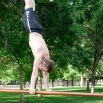 GymnasticBodies athlete shows confidence in his handstand.