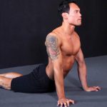 GymnasticBodies athlete demonstrates thoracic mobility with a seal stretch.