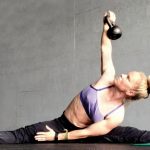 GymnasticBodies female athlete demonstrates oblique strength with a weighted side pancake.