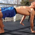 GymnasticBodies athlete demonstrates how to increase shoulder mobility with a modified crab walk.