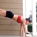 GymnasticBodies female athlete works out from home.