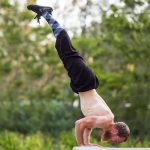 GymnasticBodies athlete demonstrates all around body strength and control with a handstand pushup.