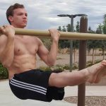 GymnasticBodies athlete demonstrates upper body strength with a chin hold.