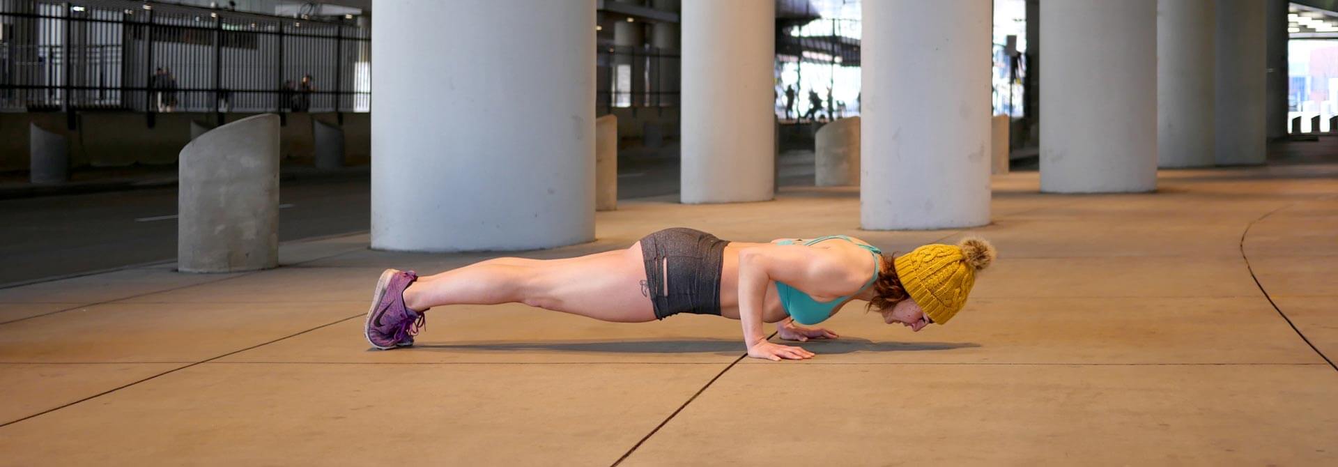 GymnasticBodies athlete demonstrates a hold at the bottom of a push-up for more strength gains. 